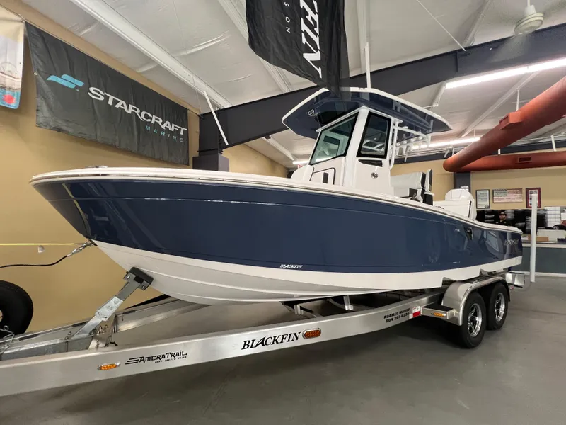 The Image of 2026 Blackfin 242 HB boat on trailer in showroom. - 1