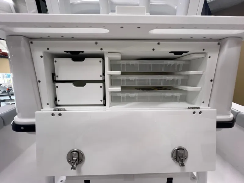 Slide: The Image of 2026 Blackfin 242 HB boat storage compartment with organized shelves and secure latches. - 13