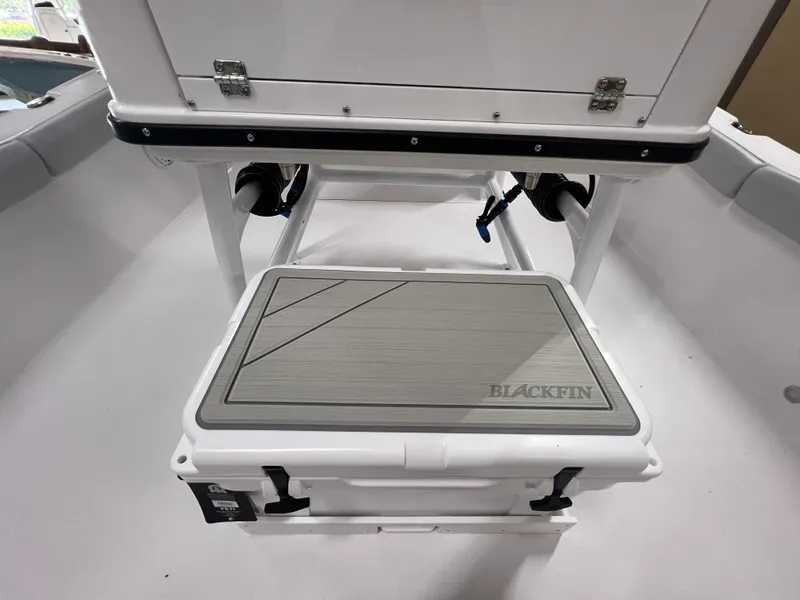 Slide: The Image of 2026 Blackfin 242 HB boat interior with a branded cooler under a seat. - 14