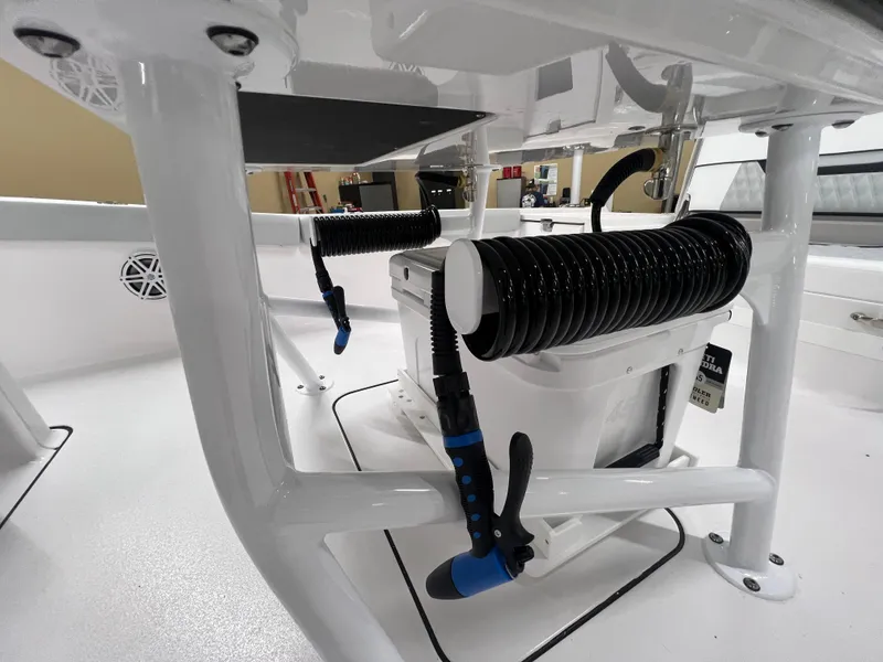 Slide: The Image of 2026 Blackfin 242 HB boat interior with storage and coiled hose. - 15