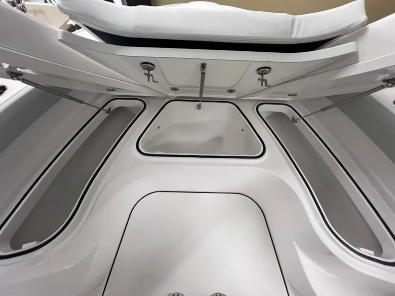 Slide: The Image of 2026 Blackfin 242 HB boat storage compartments with open hatches, showcasing spacious interior design. - 21