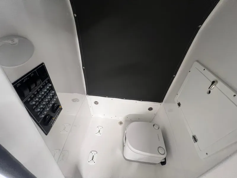 Slide: The Image of Interior of 2026 Blackfin 242 HB boat featuring a compact marine toilet. - 24