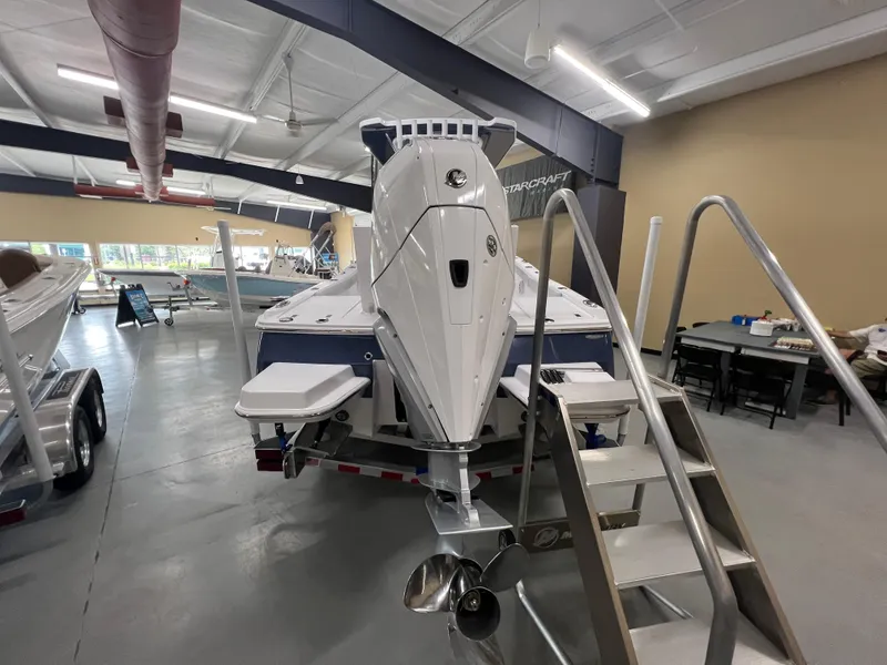 Slide: The Image of 2026 Blackfin 242 HB boat displayed indoors, showcasing its powerful engine and sleek design. - 3