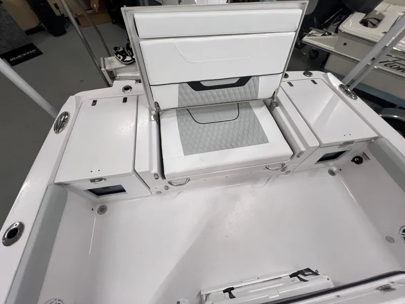 Slide: The Image of 2026 Blackfin 242 HB boat interior with white seating and storage compartments. - 6