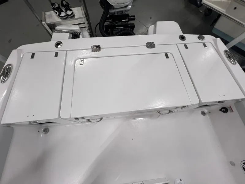 Slide: The Image of 2026 Blackfin 242 HB boat deck with storage compartments and sleek design. - 7
