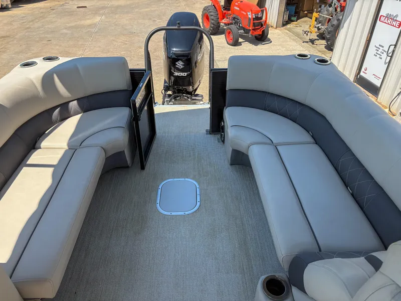 Slide: The Image of 2018 Silver Wave 250 Grand Costa CL pontoon boat interior with plush seating and Suzuki outboard motor. - 10
