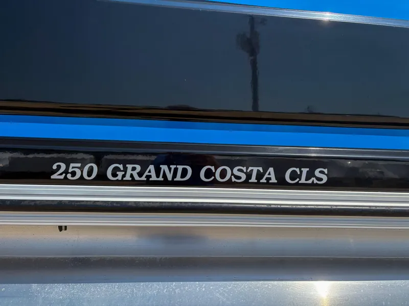 Slide: The Image of Close-up of 2018 Silver Wave 250 Grand Costa CL boat model nameplate. - 2