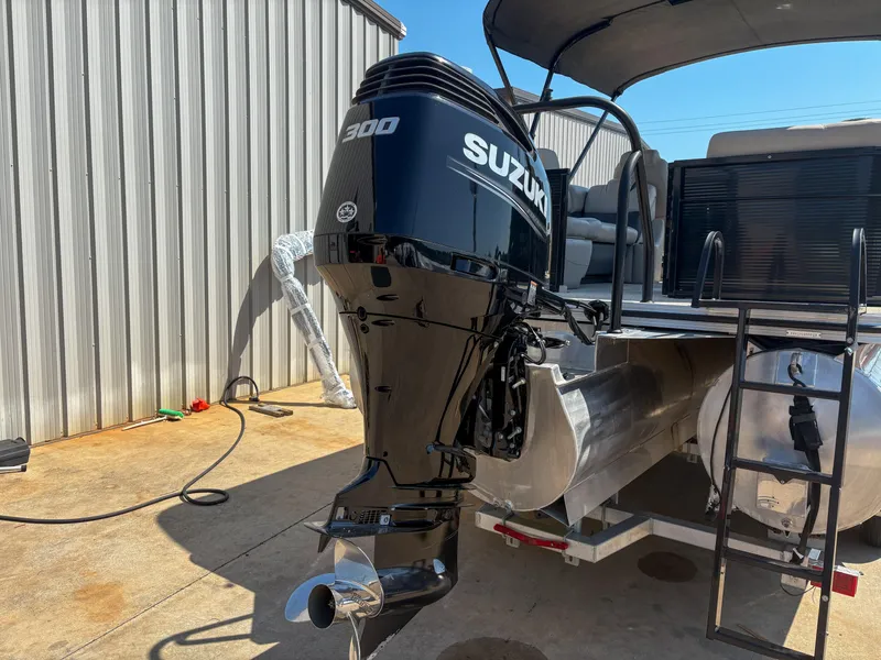 Slide: The Image of 2018 Silver Wave 250 Grand Costa CL with Suzuki 300 outboard motor, docked near metal building. - 5