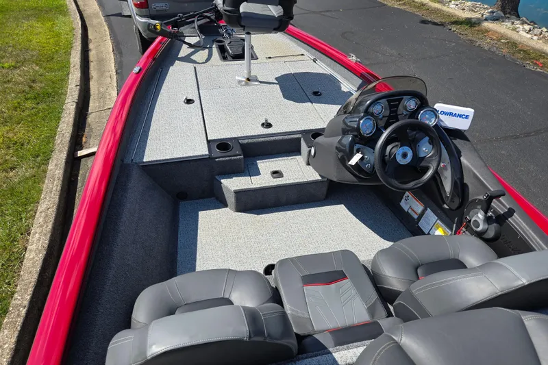 Slide: The Image of 2024 Tracker Pro Team 175 TXW boat interior with steering console and seating. - 11