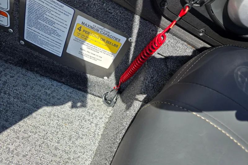 Slide: The Image of 2024 Tracker Pro Team 175 TXW boat interior with safety capacity label and red safety cord. - 13