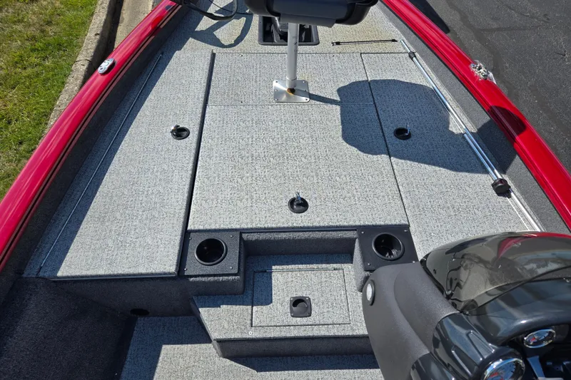 Slide: The Image of 2024 Tracker Pro Team 175 TXW boat interior with gray carpet and red trim. - 14