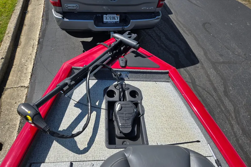 Slide: The Image of 2024 Tracker Pro Team 175 TXW boat with trolling motor, parked behind a vehicle. - 17