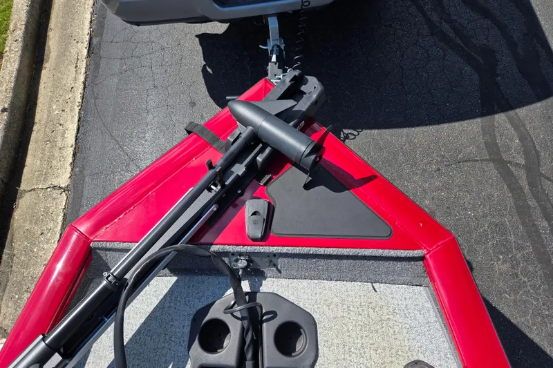 Slide: The Image of 2024 Tracker Pro Team 175 TXW boat bow with trolling motor, red and gray design. - 18