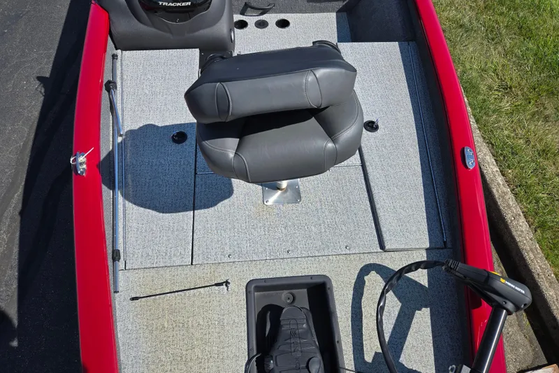 Slide: The Image of 2024 Tracker Pro Team 175 TXW boat interior with gray seating and red exterior. - 19