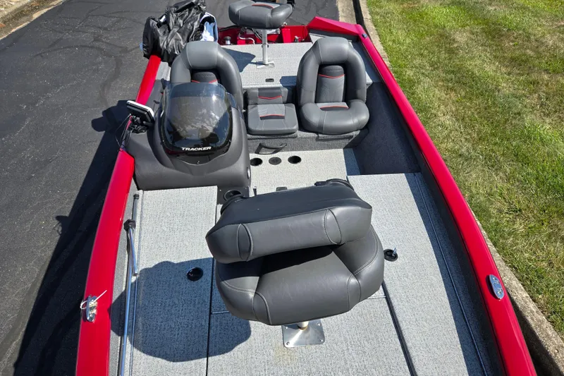 Slide: The Image of 2024 Tracker Pro Team 175 TXW boat interior with gray seating and red accents. - 20
