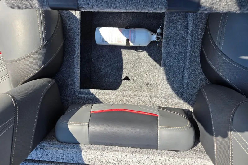 Slide: The Image of 2024 Tracker Pro Team 175 TXW boat interior with storage compartment and fire extinguisher. - 22