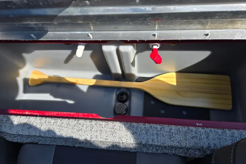 Slide: The Image of 2024 Tracker Pro Team 175 TXW storage compartment with wooden paddle and valves. - 23