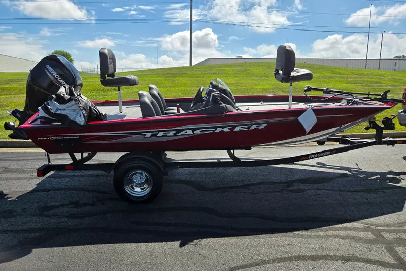 Slide: The Image of 2024 Tracker Pro Team 175 TXW boat on trailer, red exterior, parked outdoors. - 4
