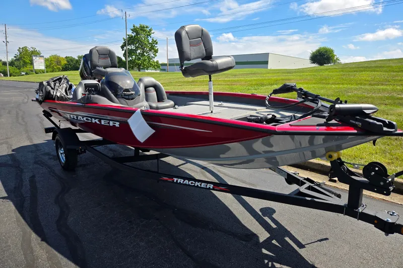 Slide: The Image of 2024 Tracker Pro Team 175 TXW boat on trailer, parked outdoors under blue sky. - 5