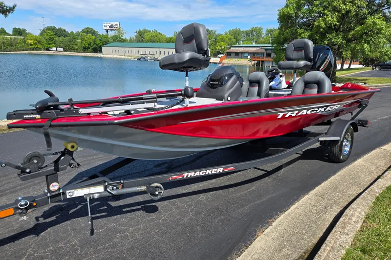 Slide: The Image of 2024 Tracker Pro Team 175 TXW boat on trailer by a lake. - 8