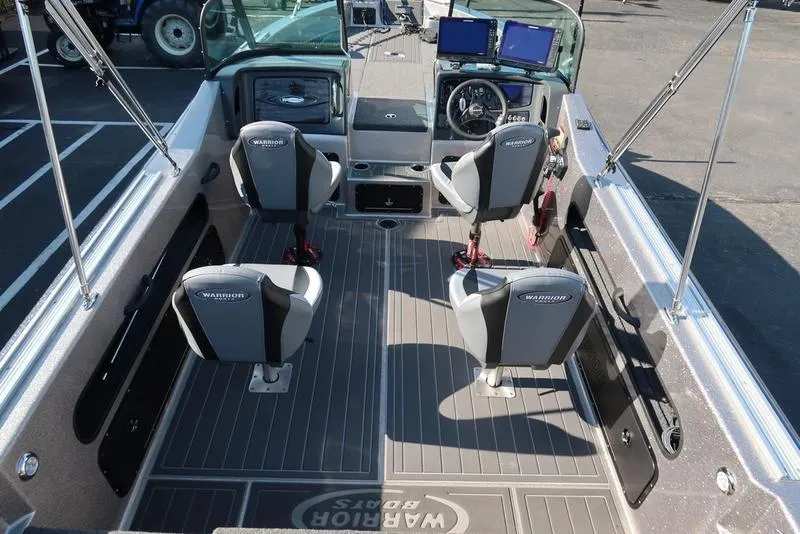 Slide: The Image of 2024 Warrior 238 DC boat interior with four seats and modern dashboard. - 17