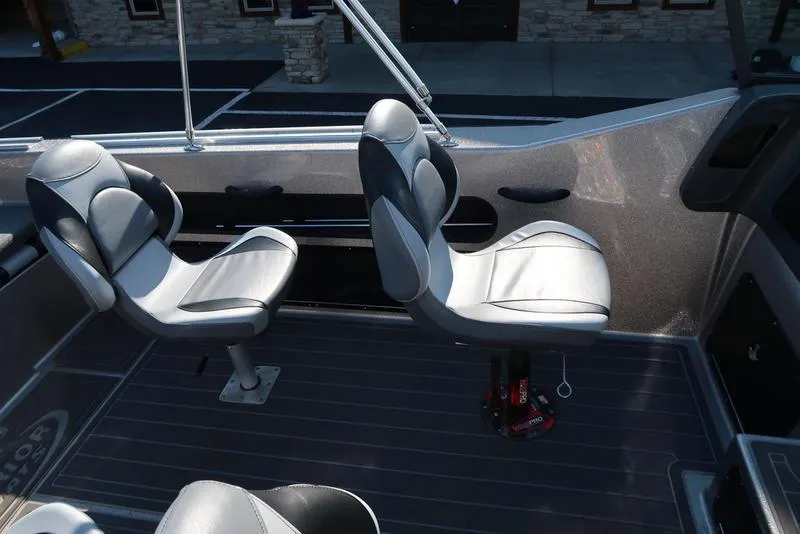 Slide: The Image of 2024 Warrior 238 DC boat interior with two swivel seats and sleek design. - 18