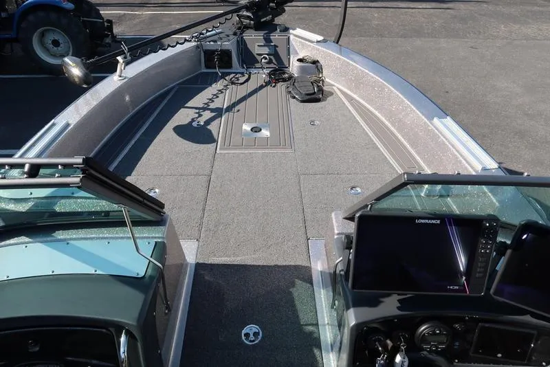 Slide: The Image of 2024 Warrior 238 DC boat interior with navigation equipment and spacious deck. - 23