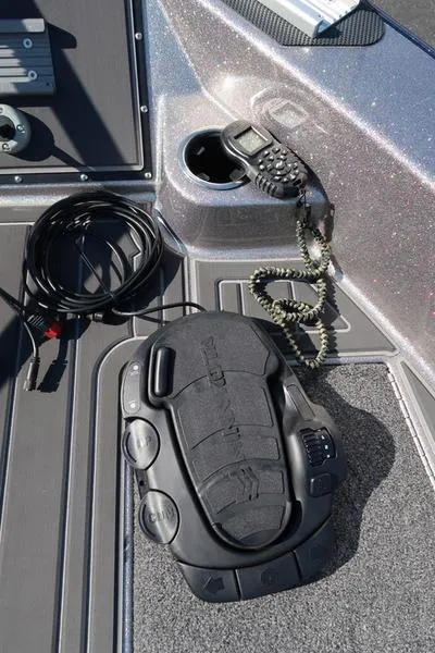 Slide: The Image of 2024 Warrior 238 DC boat deck with control panel and coiled cable. - 27