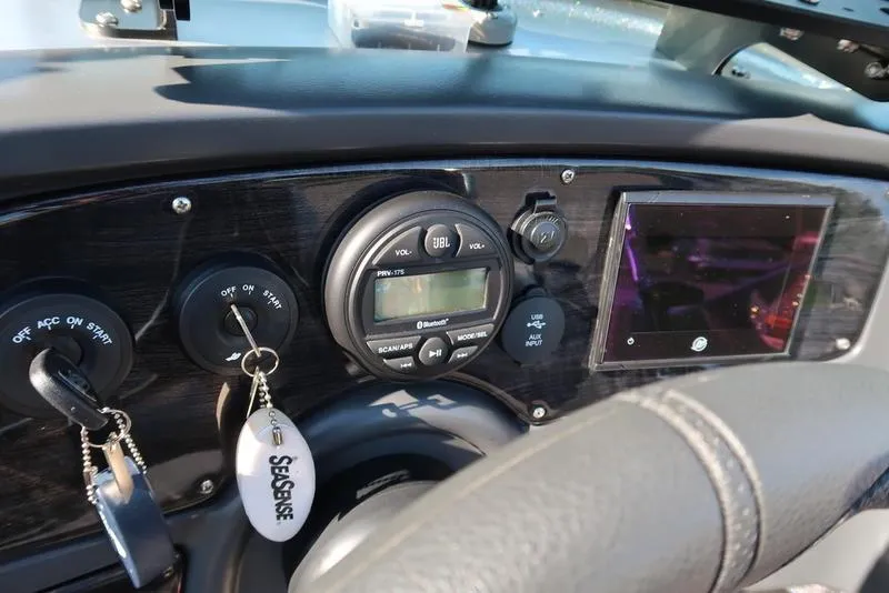 Slide: The Image of Dashboard of 2024 Warrior 238 DC boat with JBL audio system and touchscreen display. - 28