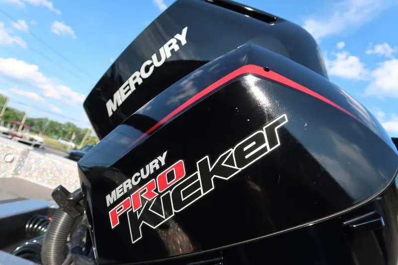 Slide: The Image of Mercury Pro Kicker engine on 2024 Warrior 238 DC boat, under clear blue sky. - 4