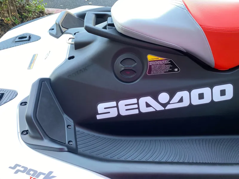 Slide: The Image of 2024 Sea-Doo Spark Trixx jet ski with red seat and bold branding. - 10