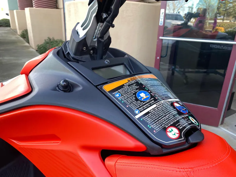 Slide: The Image of 2024 Sea-Doo Spark Trixx dashboard with safety instructions and vibrant red design. - 4