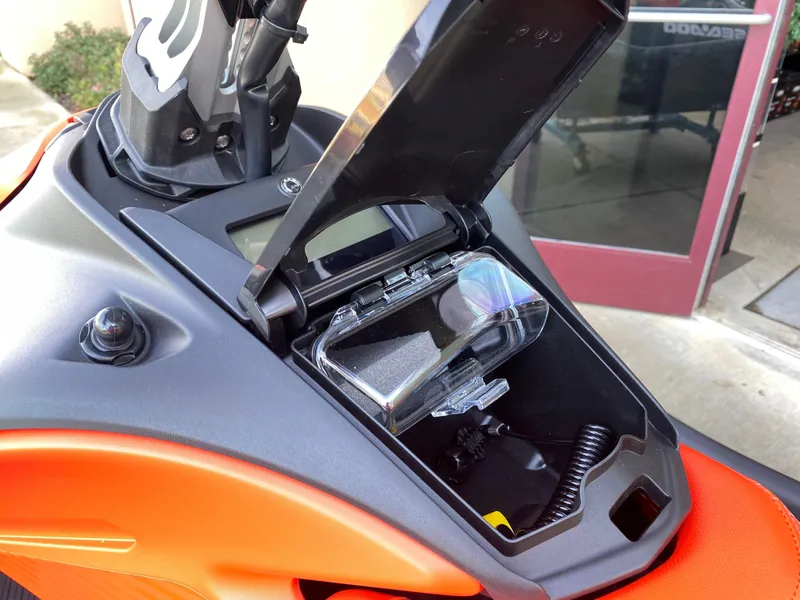 Slide: The Image of 2024 Sea-Doo Spark Trixx storage compartment open, showcasing interior features and design. - 5