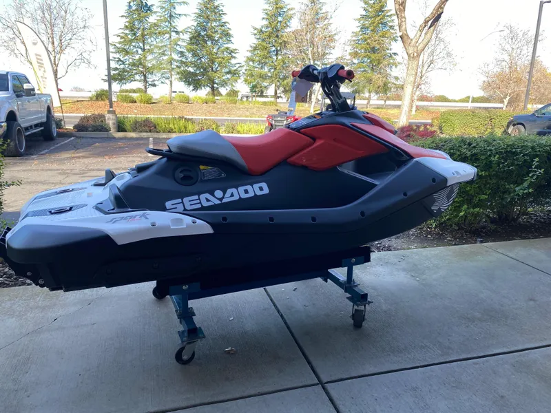 Slide: The Image of 2024 Sea-Doo Spark Trixx jet ski on display outdoors, side view. - 9