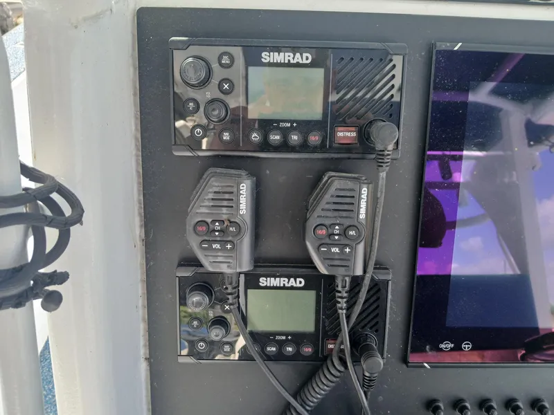Slide: The Image of Simrad marine radio equipment on Razor Cat 37 Cat, 2023 model, with control panel. - 16