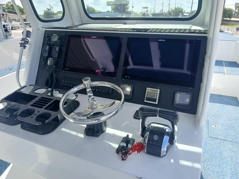 Slide: The Image of Control panel of 2023 Razor Cat 37 Cat boat with steering wheel and navigation screens. - 17