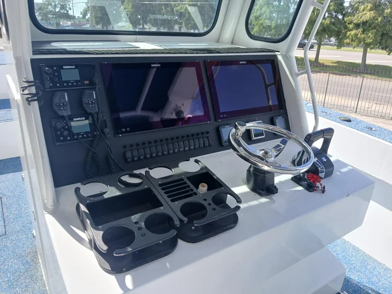 Slide: The Image of Control panel of 2023 Razor Cat 37 Cat boat with navigation screens and steering wheel. - 18
