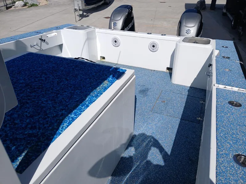 Slide: The Image of 2023 Razor Cat 37 Cat boat interior with blue deck and dual Suzuki engines. - 19