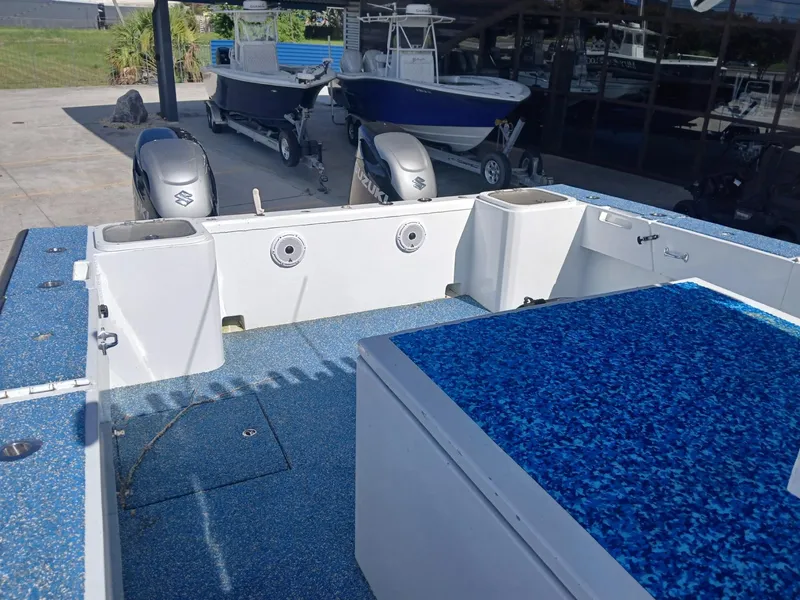 Slide: The Image of 2023 Razor Cat 37 Cat boat interior with blue deck and Suzuki engines. - 20