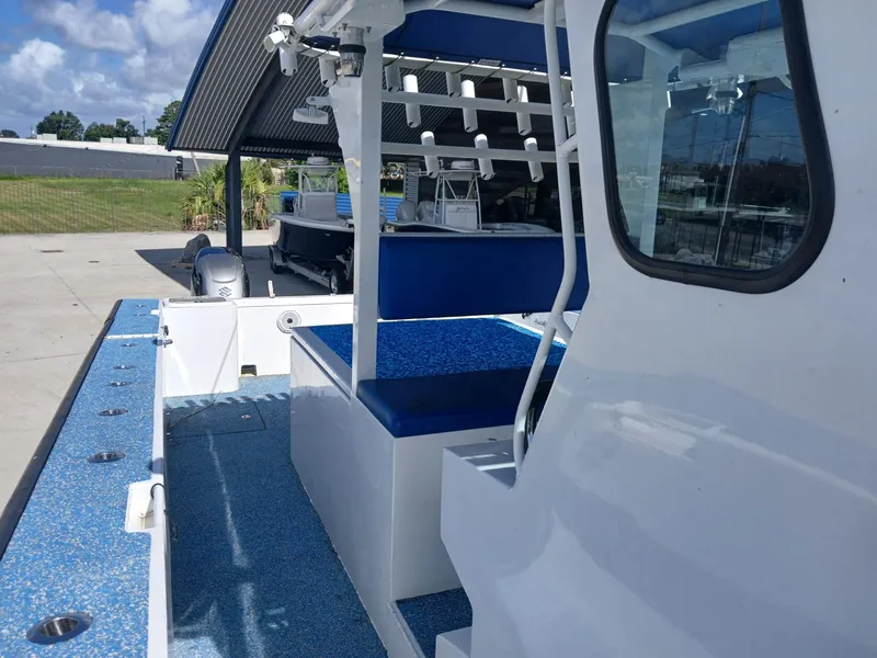 Slide: The Image of 2023 Razor Cat 37 Cat boat interior with blue seating and rod holders. - 21