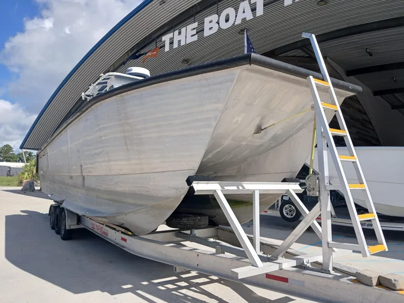 Slide: The Image of 2023 Razor Cat 37 Cat boat on trailer outside a boat dealership. - 24