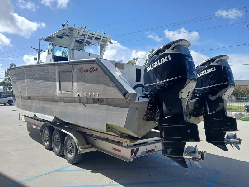 Slide: The Image of 2023 Razor Cat 37 Cat boat with dual Suzuki engines on a trailer. - 26