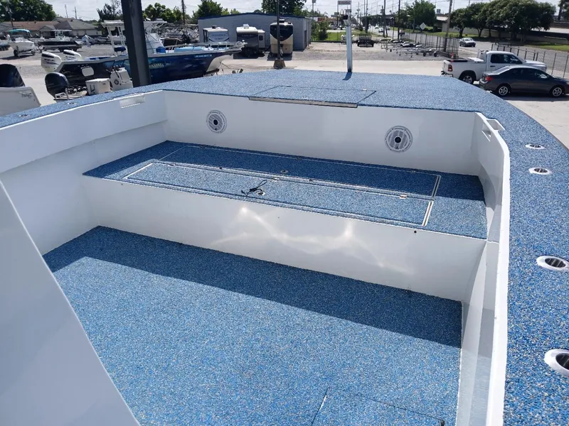 Slide: The Image of 2023 Razor Cat 37 Cat boat deck with blue non-slip surface in a marina setting. - 4