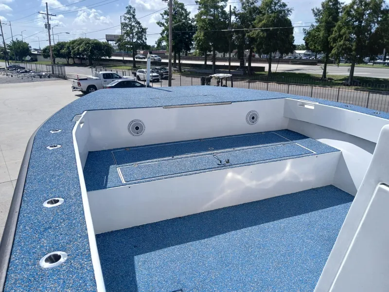 Slide: The Image of 2023 Razor Cat 37 Cat boat deck with blue non-slip surface, docked outdoors. - 5