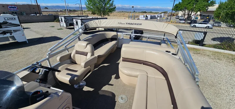 Slide: The Image of 2017 Sun Tracker Party Barge 240 pontoon boat with beige seating, parked outdoors. - 12