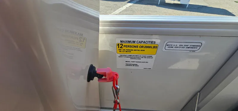 Slide: The Image of 2017 Sun Tracker Party Barge 240 capacity label, showing 12-person or 2000 lbs limit. - 14