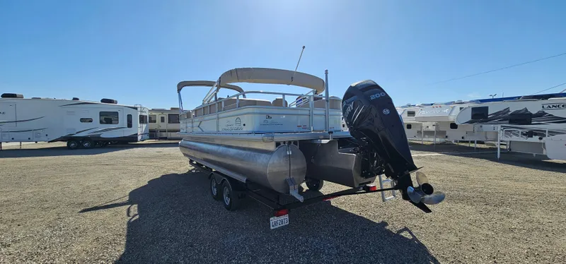 Slide: The Image of 2017 Sun Tracker Party Barge 240 pontoon boat with outboard motor in a parking lot. - 4