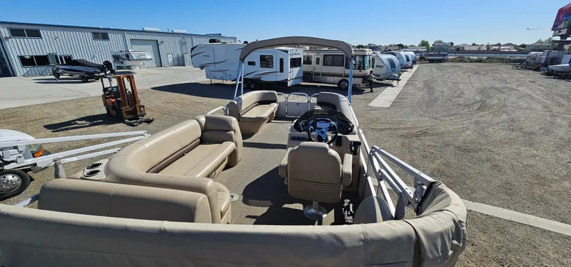 Slide: The Image of 2017 Sun Tracker Party Barge 240 pontoon boat in storage lot with RVs and trailers. - 5