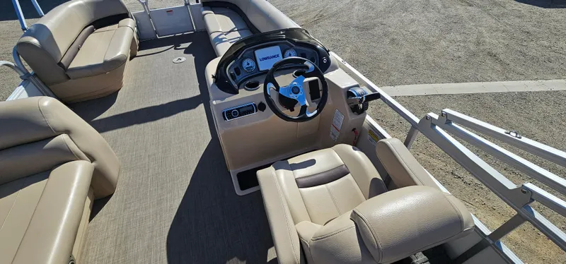 Slide: The Image of 2017 Sun Tracker Party Barge 240 interior with beige seating and steering console. - 7