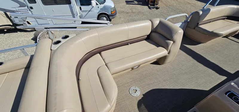Slide: The Image of 2017 Sun Tracker Party Barge 240 with beige seating and spacious deck area. - 8